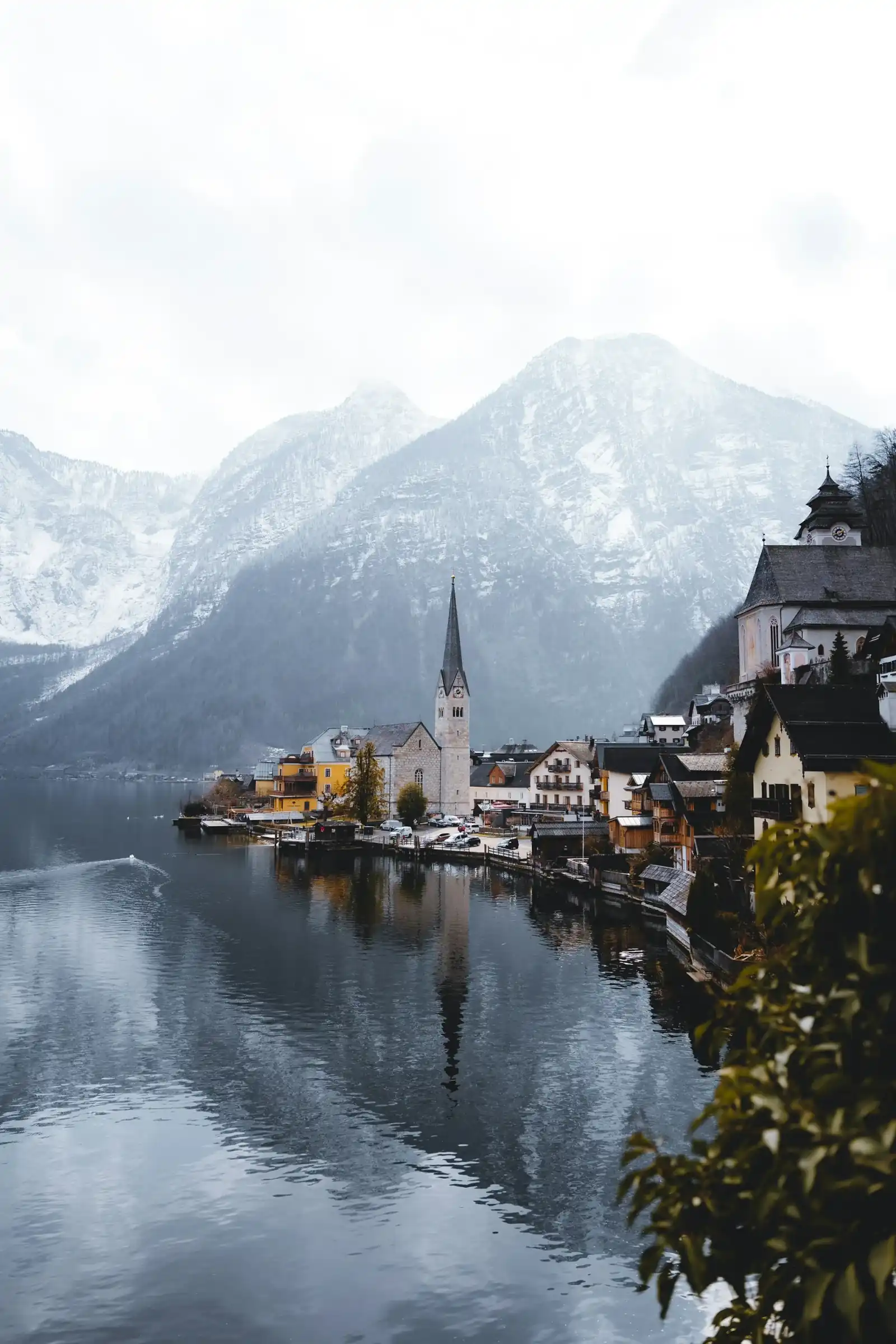 Hallstatt village and snow-dusted mountains reflected in the lake