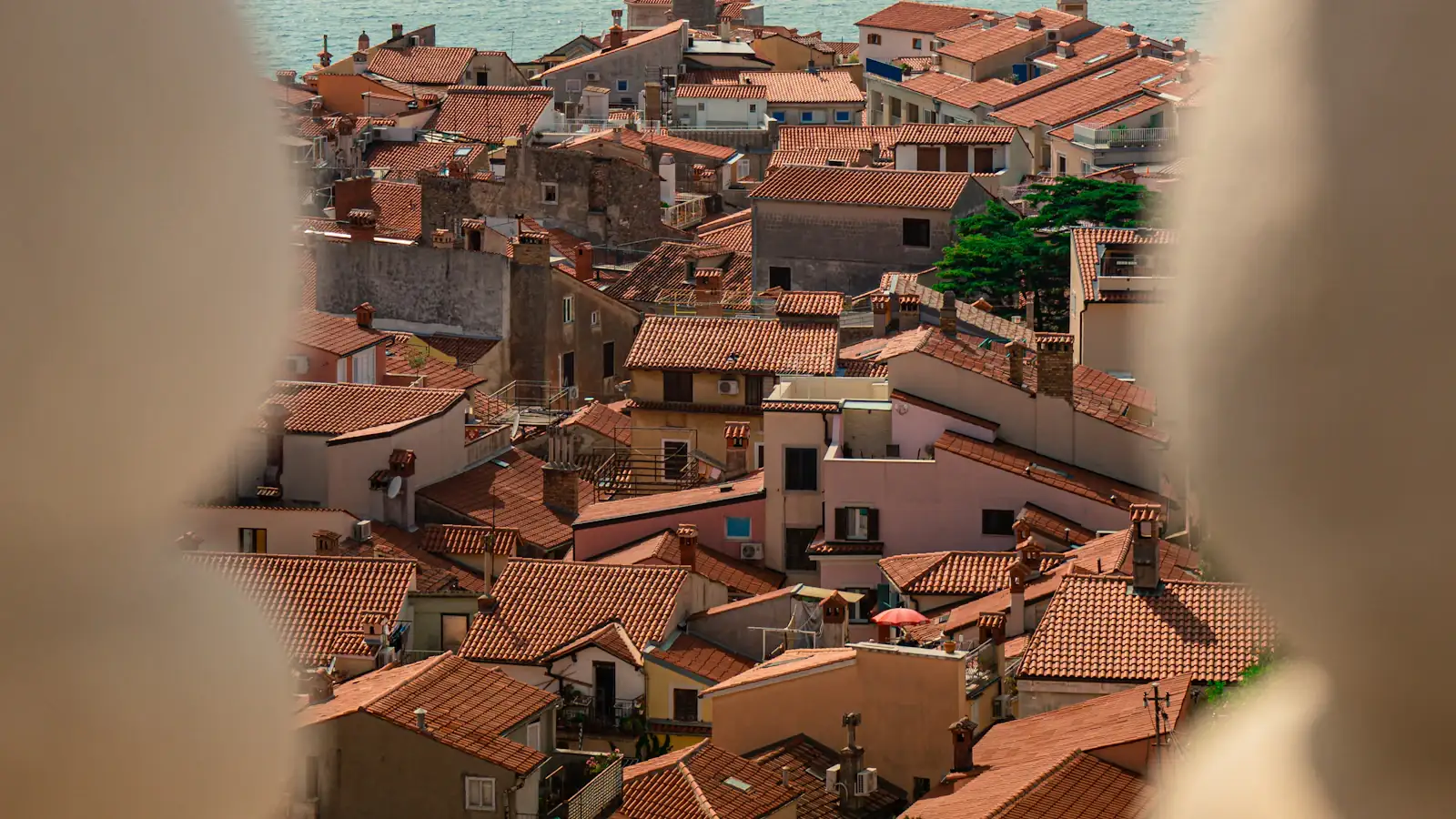 Piran rooftops, bell tower and the Adriatic Sea viewed from above