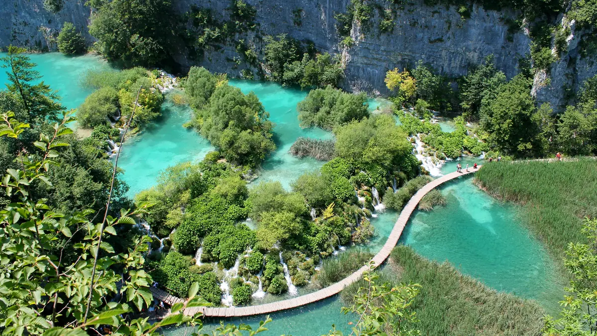 Turquoise lakes, forest and wooden visitor walkways at Plitvice Lakes National Park