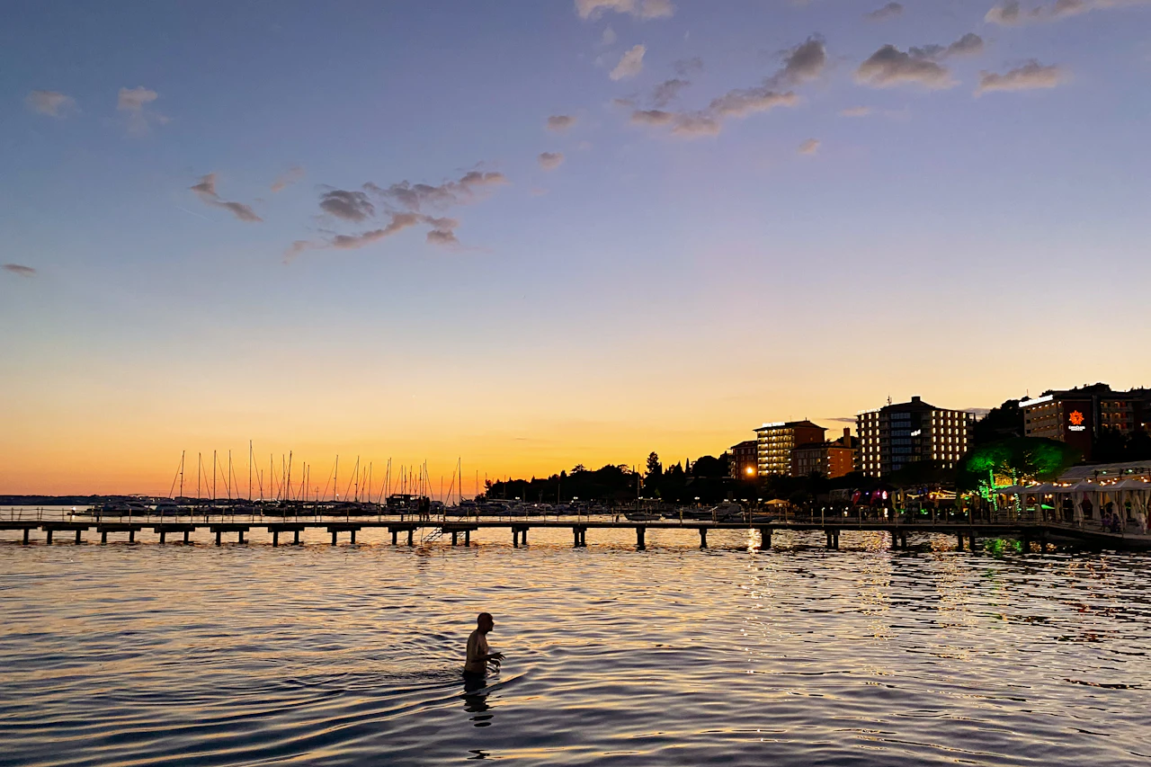 Portorož waterfront and buildings beside the Adriatic Sea at sunset