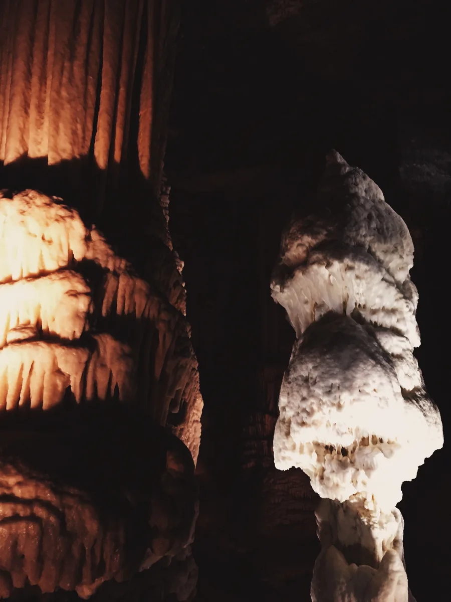Illuminated limestone formations inside Postojna Cave