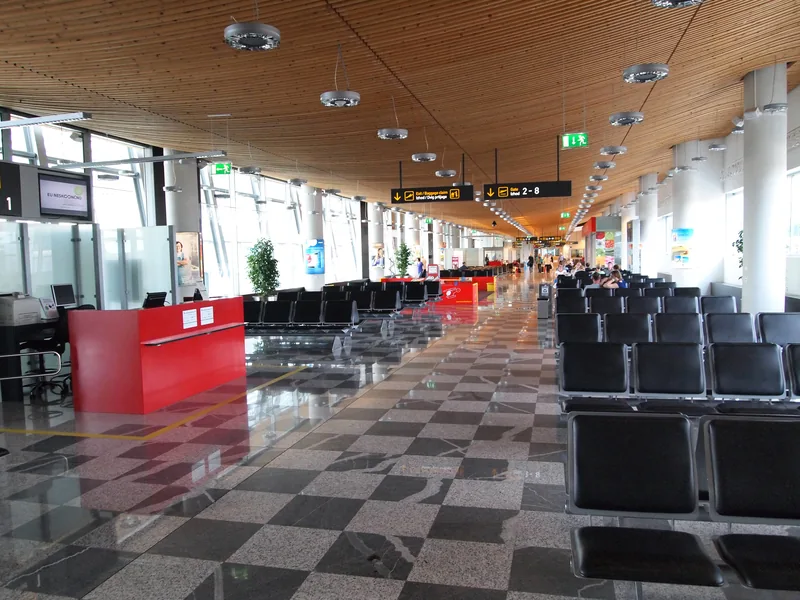 Seating and departure signs inside Ljubljana Airport